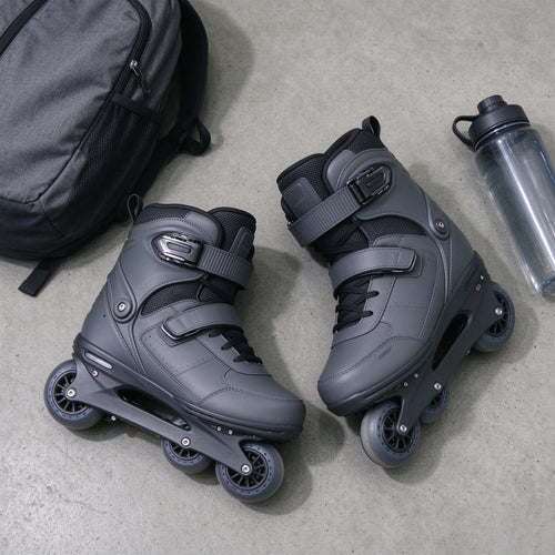 Grey electric skates with a backpack and water bottle